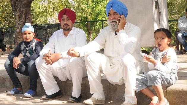 The deceased’s father Jaspal Singh Dhillon and brother Darshan Singh Dhillon with his children in Chandigarh on Monday.(Anil Dayal/HT Photo)