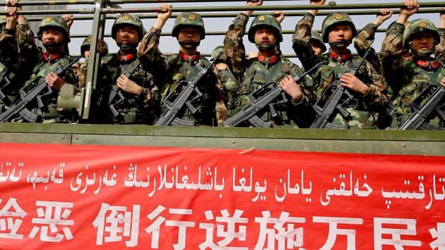 Chinese military police attend an anti-terrorist oath-taking rally in Hetian, northwest China's Xinjiang Uighur Autonomous Region. (AFP File Photo) Chinese military police attend an anti-terrorist oath-taking rally in Hetian, northwest China's Xinjiang Uighur Autonomous Region. (AFP File Photo)