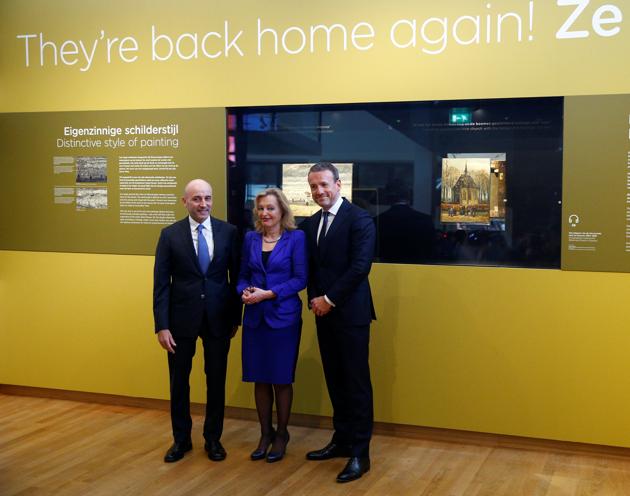 General of the Italian finance police Gianluigi D'alfonso, museum director Axel Ruger and Dutch minister of education, culture and science Jet Bussemaker reveal the two recovered paintings.(Reuters)