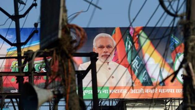 A BJP election campaign hoarding in UP ahead of the state Assembly elections in Varanasi. The Delhi high court has sought the Centre’s reply to a contempt plea over not taking action against parties, including the BJP and Congress, for accepting foreign funds.(AFP File Photo)