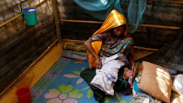 Fatema, 25, sits beside her one-day-old daughter Aasma in Kutupalang unregistered refugee camp in Cox’s Bazar, Bangladesh, February 9, 2017. Fatema fled to Bangladesh from Jambuinna village in Myanmar two months ago after her house was burnt down by the military. She crossed Naf River by boat during the night. ‘Our situation is better than many other refugees as my husband Mohammad Alom works here as a day labourer. Many of the new refugees have no work here, so they have to rely on relief,’ Fatema said. (Mohammad Ponir Hossain/REUTERS)