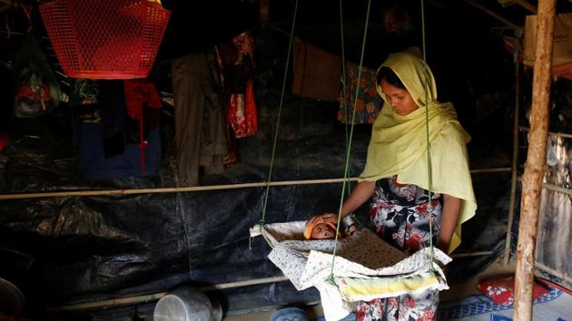 Aarafa Begum, 20, tends to her two-month-old daughter Noor Kayes, who has been suffering from fever in Kutupalang unregistered refugee camp in Cox’s Bazar. Aarafa Begum fled to Bangladesh two and a half months ago with her husband, mother-in-law and sister-in-law from Khyeri Prang in Myanmar. ‘My daughter is suffering from fever since last night but I don’t know where the clinic is, ‘Aarafa said. (Mohammad Ponir Hossain/REUTERS)