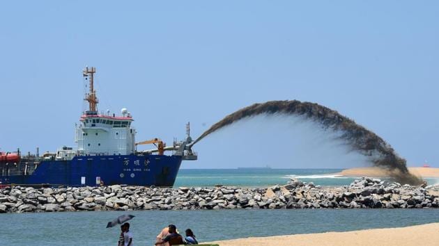 A dredger pumps sand to reclaim land outside the port of Colombo as part of a $1.4-billion real estate development by China.(AFP)