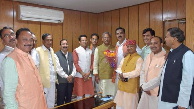 MLAs welcome chief minister Trivendra Singh Rawat after the oath taking ceremony at the assembly in Dehradun on Tuesday.(PTI Photo)