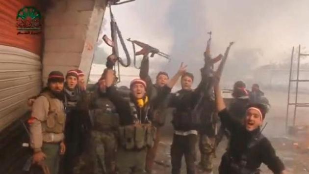 A still image taken from a video uploaded on social media on March 20, 2017, shows fighters, said to be members of Ahrar Al Sham group, holding up their weapons and cheering, said to be in Damascus, Syria. (Reuters) A still image taken from a video uploaded on social media on March 20, 2017, shows fighters, said to be members of Ahrar Al Sham group, holding up their weapons and cheering, said to be in Damascus, Syria. (Reuters)