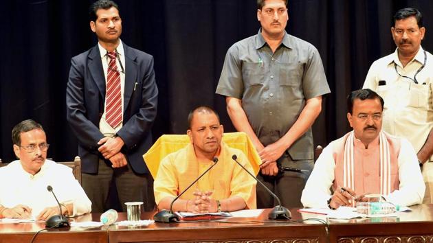 UP chief minister Yogi Adityanath with deputy CMs Dinesh Sharma and Keshav Prasad Muriya at a meeting of police officers at the Lok Bhawan, Lucknow.(PTI File Photo)