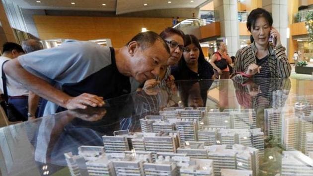 Potential buyers look at models of a new public housing estate to be constructed in Singapore (Reuters photo) Potential buyers look at models of a new public housing estate to be constructed in Singapore (Reuters photo)