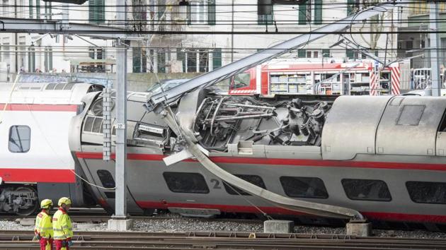 Rescuers stand next to a derailed train in the station of Lucerne, Switzerland, Wednesday, March 22, 2017.(AP)