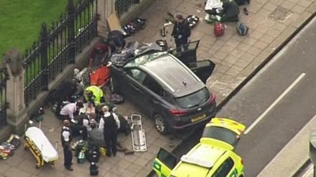 In this image taken from video police officers gather around a car adjacent to Houses of Parliament in London, Wednesday, after the House of Commons sitting was suspended as witnesses reported sounds like gunfire outside.(AP Photo)