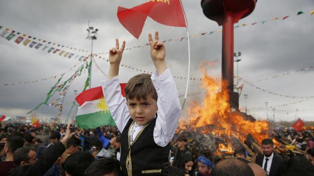 People gather around a bonfire after Turkish authorities permitted the Newroz celebration. (Lefteris Pitarakis/AP) People gather around a bonfire after Turkish authorities permitted the Newroz celebration. (Lefteris Pitarakis/AP)