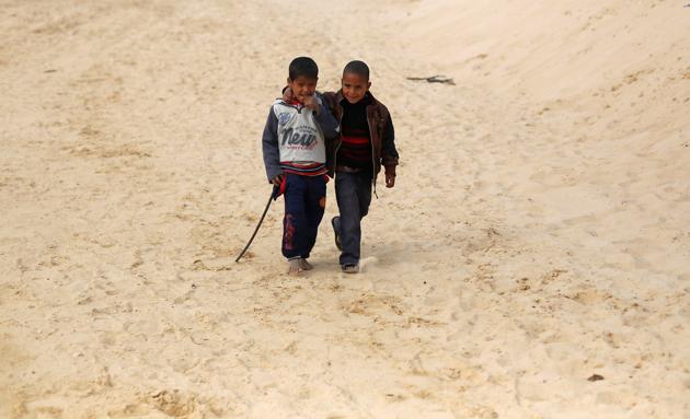 Faysal (L), a 7-year-old jockey, walks with his brother Amin during the opening of the International Camel Racing festival . (Amr Abdallah Dalsh / Reuters) Faysal (L), a 7-year-old jockey, walks with his brother Amin during the opening of the International Camel Racing festival . (Amr Abdallah Dalsh / Reuters)