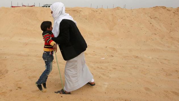 Salem, a 6-year-old jockey, is hugged by his father after winning the first round . (Amr Abdallah Dalsh / Reuters) Salem, a 6-year-old jockey, is hugged by his father after winning the first round . (Amr Abdallah Dalsh / Reuters)