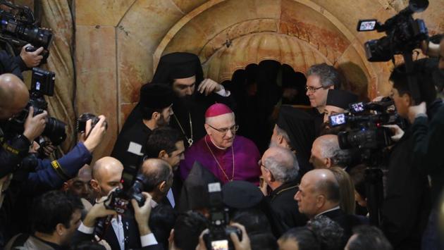 Papal Nuncio Archbishop Giuseppe Lazzarotto (C) is seen during the renovation completion ceremony next to the Edicule surrounding the Tomb of Jesus at the Church of the Holy Sepulchre. A team of scientists and restorers have completed work on one of Christianities most sacred monuments in the Church of the Holy Sepulchre in Jerusalem. (Menahem Kahana/AFP) Papal Nuncio Archbishop Giuseppe Lazzarotto (C) is seen during the renovation completion ceremony next to the Edicule surrounding the Tomb of Jesus at the Church of the Holy Sepulchre. A team of scientists and restorers have completed work on one of Christianities most sacred monuments in the Church of the Holy Sepulchre in Jerusalem. (Menahem Kahana/AFP)