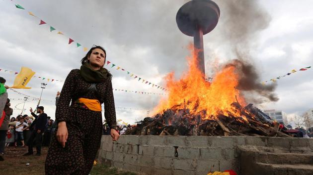 A woman walks past a bonfire during a gathering celebrating Newroz. This weekend, Turkey responded with fury after tens of thousands of people attended a pro-Kurdish protest in Germany, many brandishing Ocalan flags and pro-PKK insignia. But only a few portraits of Ocalan could be seen at the Diyarbakir rally. (Sertac Kayar/REUTERS) A woman walks past a bonfire during a gathering celebrating Newroz. This weekend, Turkey responded with fury after tens of thousands of people attended a pro-Kurdish protest in Germany, many brandishing Ocalan flags and pro-PKK insignia. But only a few portraits of Ocalan could be seen at the Diyarbakir rally. (Sertac Kayar/REUTERS)