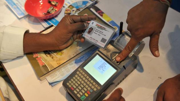A man gives his thumb impression to withdraw money from his bank account using his Aadhaar card. (AFP File Photo) A man gives his thumb impression to withdraw money from his bank account using his Aadhaar card. (AFP File Photo)