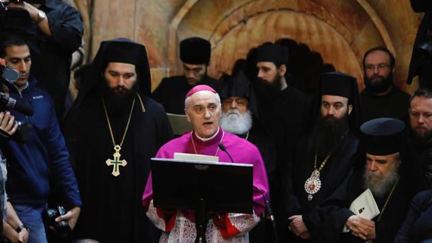 Papal Nuncio Archbishop Giuseppe Lazzarotto (C) talks during the renovation completion ceremony next to the Edicule surrounding the Tomb of Jesus at the Church of the Holy Sepulchre. At the centre of the restoration work was a small structure above the burial chamber, known as the Edicule, on which a team of about 50 experts from the National Technical fUniversity of Athens, which had previously worked on the Acropolis in the Greek capital and the Hagia Sophia in Istanbul, worked for almost nine months. (Menahem Kahana/AFP) Papal Nuncio Archbishop Giuseppe Lazzarotto (C) talks during the renovation completion ceremony next to the Edicule surrounding the Tomb of Jesus at the Church of the Holy Sepulchre. At the centre of the restoration work was a small structure above the burial chamber, known as the Edicule, on which a team of about 50 experts from the National Technical fUniversity of Athens, which had previously worked on the Acropolis in the Greek capital and the Hagia Sophia in Istanbul, worked for almost nine months. (Menahem Kahana/AFP)