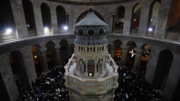 Christian clergymen and other guests attend a ceremony next to the Edicule surrounding the Tomb of Jesus. A marble slab covering the rock carved tomb was lifted for the first time in October last year in more than two centuries, allowing restoration workers to examine the original rock shelf or “burial bed” on which Jesus’ body is thought to have rested. (Menahem Kahana/AFP) Christian clergymen and other guests attend a ceremony next to the Edicule surrounding the Tomb of Jesus. A marble slab covering the rock carved tomb was lifted for the first time in October last year in more than two centuries, allowing restoration workers to examine the original rock shelf or “burial bed” on which Jesus’ body is thought to have rested. (Menahem Kahana/AFP)