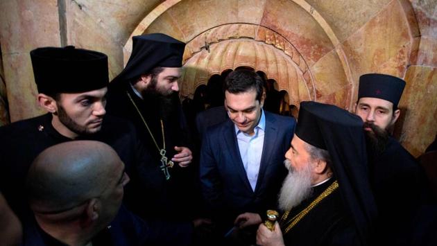 Greek Prime Minister Alexis Tsipras (C) and Greek Orthodox Patriarch of Jerusalem Theophilos III (C-R) walk out of the Edicule following a ceremony at the Church of the Holy Sepulchre. The work involved the use of radar, laser scanners and drones. The structure needed reinforcement and conservation, including installation of an underground drainage network for rainwater and sewage, said Antonia Moropoulou, a professor at the National Technical University of Athens, who oversaw the restoration work. (Sebastian Scheiner/AFP) Greek Prime Minister Alexis Tsipras (C) and Greek Orthodox Patriarch of Jerusalem Theophilos III (C-R) walk out of the Edicule following a ceremony at the Church of the Holy Sepulchre. The work involved the use of radar, laser scanners and drones. The structure needed reinforcement and conservation, including installation of an underground drainage network for rainwater and sewage, said Antonia Moropoulou, a professor at the National Technical University of Athens, who oversaw the restoration work. (Sebastian Scheiner/AFP)