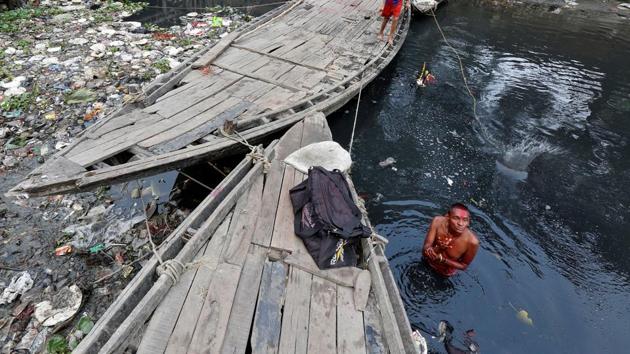 A man offers a prayer as he takes a dip in the polluted waters of Tolly's Nullah in Kolkata. (Rupak De Chowdhuri / REUTERS) A man offers a prayer as he takes a dip in the polluted waters of Tolly's Nullah in Kolkata. (Rupak De Chowdhuri / REUTERS)