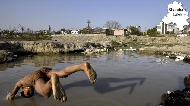 A child jumps in to the Shahdara lake, which has been turned into a garbage dump over the years, in East Delhi. Data available with the Delhi government says there are over 1,000 water bodies in the capital but due to encroachment and urbanisation, nearly 80% just exist on paper, say activists. (Arun Sharma/HT PHOTO) A child jumps in to the Shahdara lake, which has been turned into a garbage dump over the years, in East Delhi. Data available with the Delhi government says there are over 1,000 water bodies in the capital but due to encroachment and urbanisation, nearly 80% just exist on paper, say activists. (Arun Sharma/HT PHOTO)
