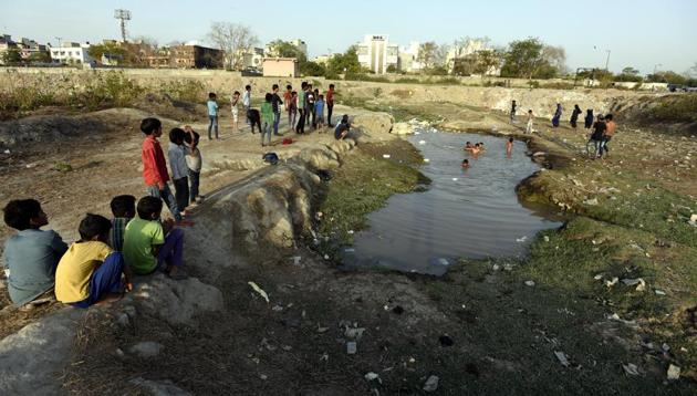 Children play at Shahdara Lake, near EMCD Office in New Delhi. (Sonu Mehta/HT PHOTO) Children play at Shahdara Lake, near EMCD Office in New Delhi. (Sonu Mehta/HT PHOTO)