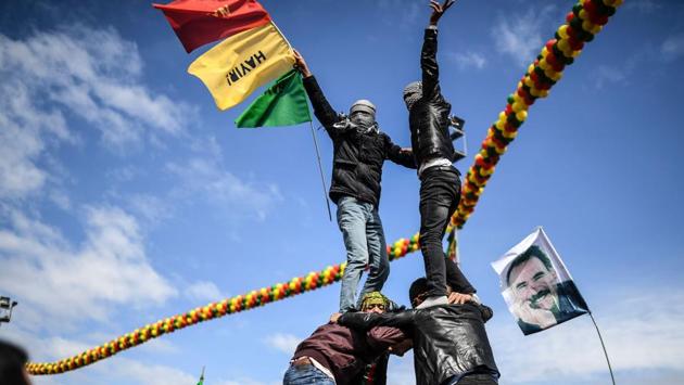 Young men build a human pyramid as Turkish Kurds gather for Newroz celebrations for the new year. Tens of thousands of people celebrated the New Year festival of Newroz in Turkey’s overwhelmingly Kurdish city of Diyarbakir on Tuesday, even as police killed a man who claimed to be carrying a bomb. (Bulent Kilic/AFP) Young men build a human pyramid as Turkish Kurds gather for Newroz celebrations for the new year. Tens of thousands of people celebrated the New Year festival of Newroz in Turkey’s overwhelmingly Kurdish city of Diyarbakir on Tuesday, even as police killed a man who claimed to be carrying a bomb. (Bulent Kilic/AFP)