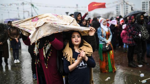 A girl looks on as Turkish Kurds gather to celebrate Newroz. Many of those attending brandished flags with the word “no” in Turkish and Kurdish, urging voters to reject a plan to expand President Recep Tayyip Erdogan’s plans in a April 16 referendum. (Bulent Kilic/AFP) A girl looks on as Turkish Kurds gather to celebrate Newroz. Many of those attending brandished flags with the word “no” in Turkish and Kurdish, urging voters to reject a plan to expand President Recep Tayyip Erdogan’s plans in a April 16 referendum. (Bulent Kilic/AFP)