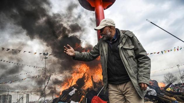 Turkish Kurds gather in front of a bonfire for Newroz celebrations. The celebration of Newroz is an annual event in Diyarbakir and other cities in Turkey, a festival that has its roots in Persian culture. (Bulent Kilic/AFP) Turkish Kurds gather in front of a bonfire for Newroz celebrations. The celebration of Newroz is an annual event in Diyarbakir and other cities in Turkey, a festival that has its roots in Persian culture. (Bulent Kilic/AFP)