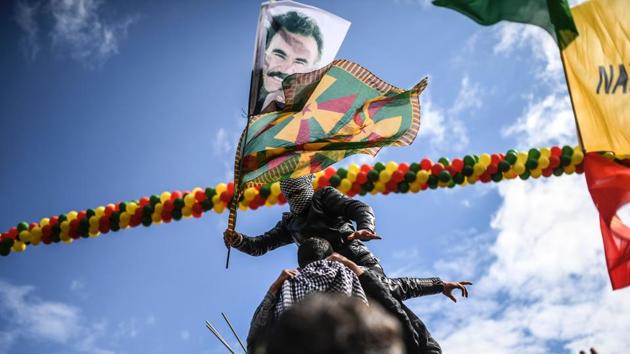 A Kurdish boy waves flags with a picture of jailed Kurdish leader Abdullah Ocalan. The event was organised by parties including the pro-Kurd Peoples’ Democratic Party (HDP), the third-largest party in the Turkish parliament. (Bulent Kilic/AFP) A Kurdish boy waves flags with a picture of jailed Kurdish leader Abdullah Ocalan. The event was organised by parties including the pro-Kurd Peoples’ Democratic Party (HDP), the third-largest party in the Turkish parliament. (Bulent Kilic/AFP)