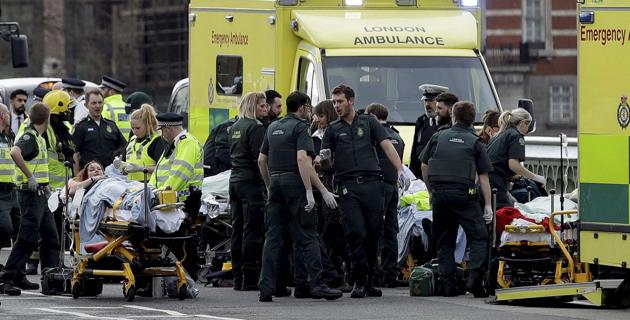 Emergency services staff provide medical attention close to the Houses of Parliament in London, Wednesday, March 22, 2017. (AP)