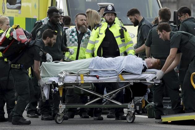 Emergency services staff provide medical attention to injured people on the south side of Westminster Bridge after a terror attack on Wednesday. (AP) Emergency services staff provide medical attention to injured people on the south side of Westminster Bridge after a terror attack on Wednesday. (AP)