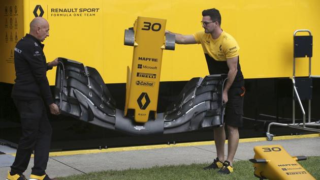 Technicians from Renault Sport carry a nose piece for a car at the track in Melbourne on Thursday. Sunday's season-opening Australian Grand Prix, where F1 rule changes requiring wider tires, greater aerodynamics thanks to among other things a sophisticated and wider nose, bigger fuel loads and increased downforce are expected to make the heavier cars significantly faster than previous years. (AP) Technicians from Renault Sport carry a nose piece for a car at the track in Melbourne on Thursday. Sunday's season-opening Australian Grand Prix, where F1 rule changes requiring wider tires, greater aerodynamics thanks to among other things a sophisticated and wider nose, bigger fuel loads and increased downforce are expected to make the heavier cars significantly faster than previous years. (AP)