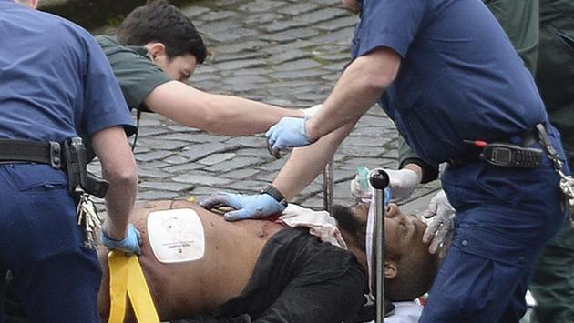 A man is treated by emergency services outside the Houses of Parliament London, Wednesday, March 22, 2017. (Stefan Rousseau / AP)