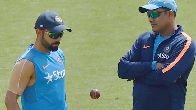 Virat Kohli, who had his injured shoulder heavily taped, had a lengthy chat with coach Anil Kumble during training session at the HPCA Stadium in Dharamsala on Thursday. The fourth India vs Australia starts from Saturday.(PTI)