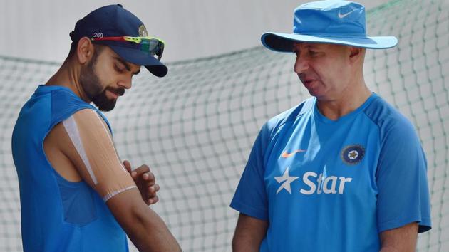 India's skipper Virat Kohli with team physiotherapist Patrick Farhart during a practice session. (PTI)