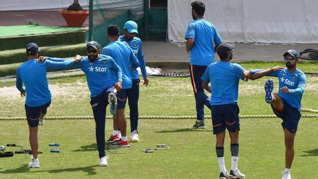 Indian cricket players warm up during a practice session ahead of the last test match against Australia at HPCA Stadium. (PTI)