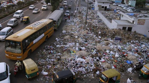 Garbage strewn along the roadside near Geeta Colony during the strike by municipal sanitation workers in June 2015. (Arun Sharma/HT Photo) Garbage strewn along the roadside near Geeta Colony during the strike by municipal sanitation workers in June 2015. (Arun Sharma/HT Photo)