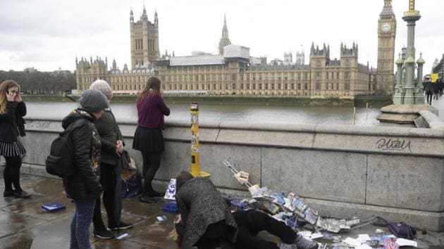 An injured woman is assisted after an incident on Westminster Bridge in London, Britain.(Reuters Photo)