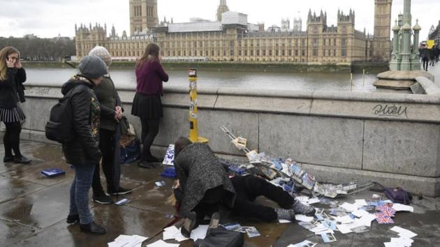 An injured woman is assisted after an incident on Westminster Bridge in London.(Reuters)