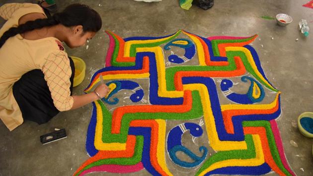 A girl making rangoli during the inter college cultural fest at Saint Soldier College, in Jalandhar. (Sikander Singh Chopra/Hindustan Times )