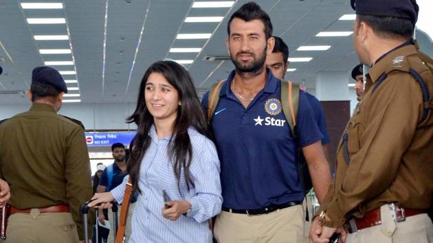 Cheteshwar Pujara arrives with his wife at Dharamsala airport ahead of the fourth and last Test match between India and Australia.(PTI)