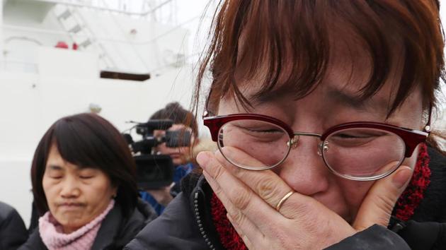 Relatives of the missing from the Sewol ferry disaster cry as they watch as a part of the damaged Sewol ferry being raised. (AFP) Relatives of the missing from the Sewol ferry disaster cry as they watch as a part of the damaged Sewol ferry being raised. (AFP)