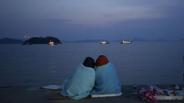 In this April 20, 2014 file photo, relatives of passengers aboard the sunken ferry Sewol sit near the sea at a port in Jindo, South Korea. Investigations into the disaster, in which 304 people died, concluded it was largely man-made -- the cumulative result of an illegal redesign, an overloaded cargo bay, inexperienced crew and a questionable relationship between the ship operators and state regulators. (Lee Jin-man/AP File Photo) In this April 20, 2014 file photo, relatives of passengers aboard the sunken ferry Sewol sit near the sea at a port in Jindo, South Korea. Investigations into the disaster, in which 304 people died, concluded it was largely man-made -- the cumulative result of an illegal redesign, an overloaded cargo bay, inexperienced crew and a questionable relationship between the ship operators and state regulators. (Lee Jin-man/AP File Photo)