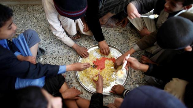 Boys eat rice for lunch at The al-Shawkani Foundation for Orphans Care. (Khaled Abdullah / Reuters) Boys eat rice for lunch at The al-Shawkani Foundation for Orphans Care. (Khaled Abdullah / Reuters)