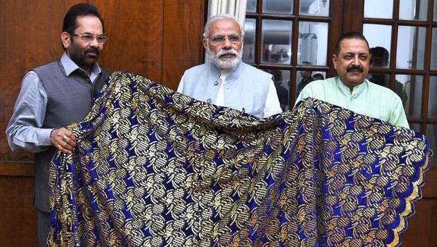 Prime Minister Narendra Modi hands over chaadar to be offered at Ajmer Dargah to Mukhtar Abbas Naqvi and Jitendra Singh in New Delhi. (PIB) Prime Minister Narendra Modi hands over chaadar to be offered at Ajmer Dargah to Mukhtar Abbas Naqvi and Jitendra Singh in New Delhi. (PIB)