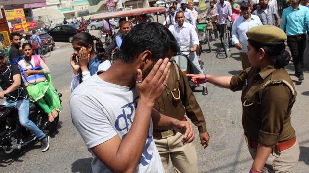 Police question men outside RGPG College for Women in Meerut on Wednesday. Across 11 districts of Uttar Pradesh, cops have hit the streets to carry out a drive against ‘Romeos’ on the orders of newly sworn-in CM Yogi Adityanath. (Chahatram/HT photo) Police question men outside RGPG College for Women in Meerut on Wednesday. Across 11 districts of Uttar Pradesh, cops have hit the streets to carry out a drive against ‘Romeos’ on the orders of newly sworn-in CM Yogi Adityanath. (Chahatram/HT photo)