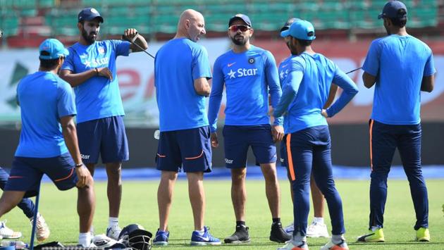 Indian captain Virat Kohli (4R) talks with physio Patrick Farhart (3L) as other teammates exercise during a training session. (AFP) Indian captain Virat Kohli (4R) talks with physio Patrick Farhart (3L) as other teammates exercise during a training session. (AFP)