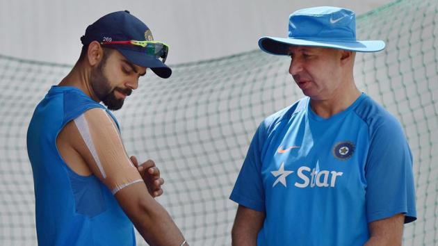 Virat Kohli with team physiotherapist Patrick Farhart during a practice session at HPCA Stadium in Dharamsala ahead of the fourth and deciding Test against Australia. (PTI) Virat Kohli with team physiotherapist Patrick Farhart during a practice session at HPCA Stadium in Dharamsala ahead of the fourth and deciding Test against Australia. (PTI)