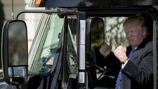 President Donald Trump gestures while sitting in an 18-wheeler truck while meeting with truckers and CEOs regarding healthcare on the South Lawn of the White House in Washington.(AP Photo)