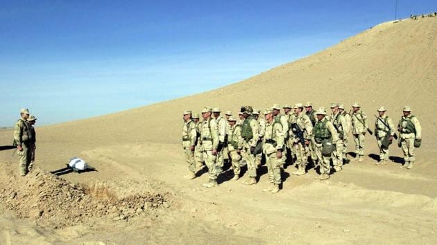 US Marines stand at attention during a military funeral for a slain Afghan warrior at Camp Rhino in southern Afghanistan on December 8, 2001. (REUTERS) US Marines stand at attention during a military funeral for a slain Afghan warrior at Camp Rhino in southern Afghanistan on December 8, 2001. (REUTERS)